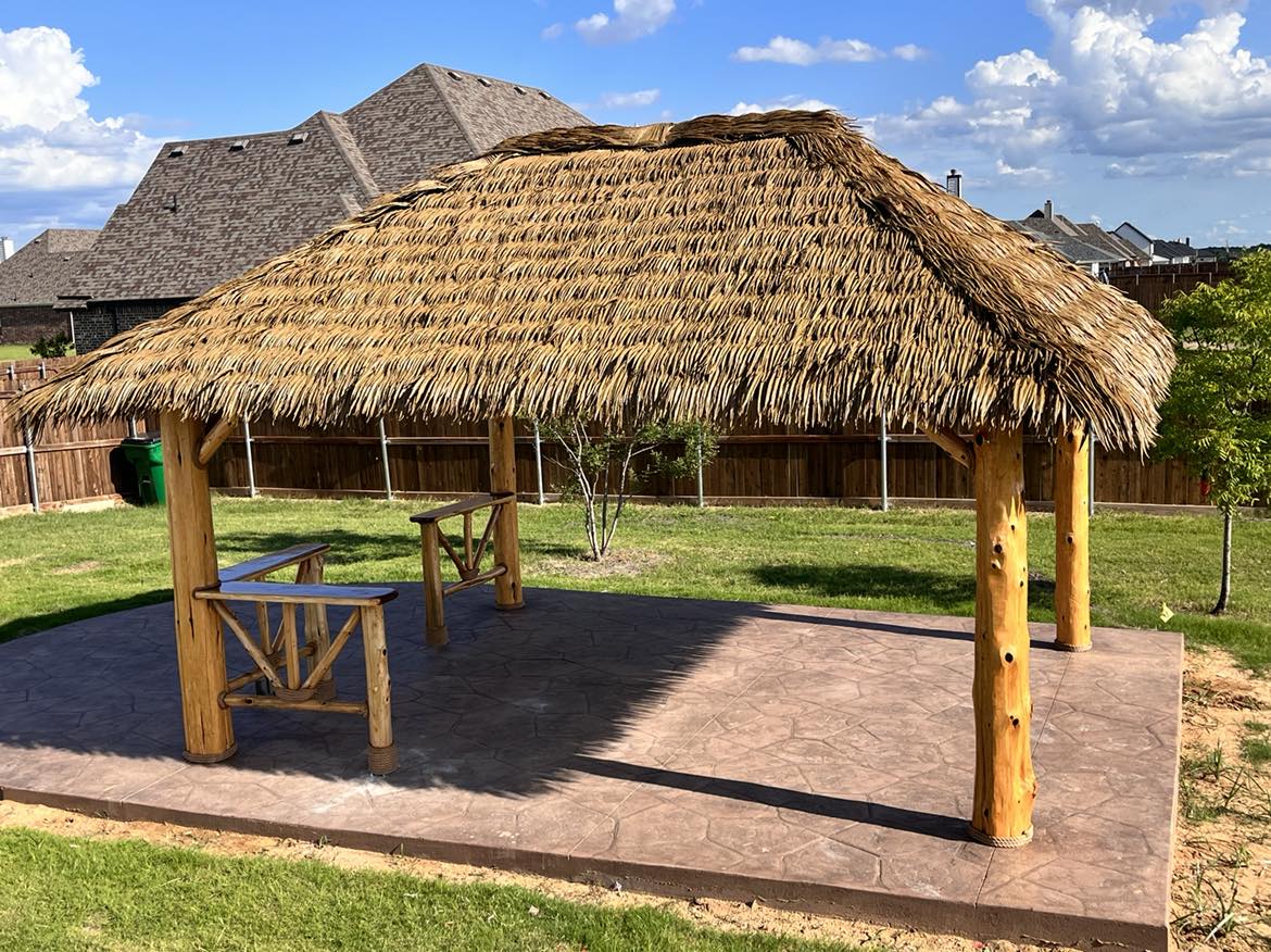 Underside of a finished palapa with cedar beams and hanging chairs